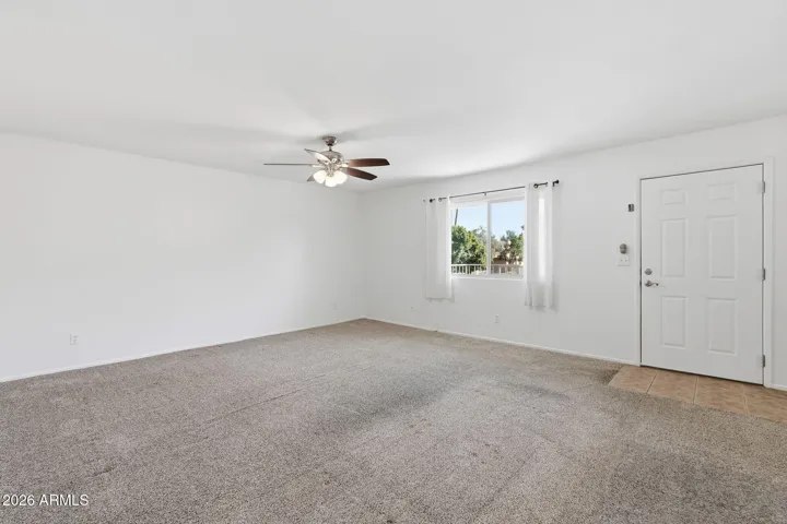 Bright and open living room in Scottsdale condo featuring a spacious layout ideal for relaxing or entertaining with seamless flow to the dining and kitchen areas.