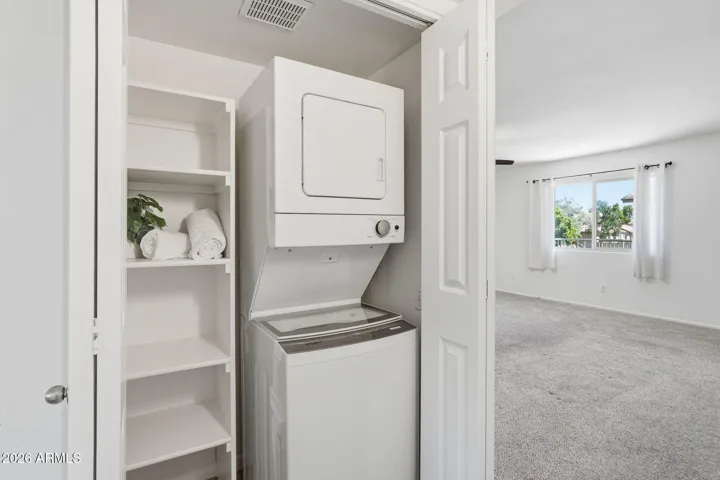Convenient stacked washer and dryer laundry closet located inside the condo, offering efficient in-home laundry and added functionality in this Scottsdale condo near Old Town and Loop 101.