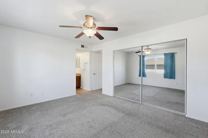 Spacious primary bedroom retreat offering comfort, privacy, and convenient access to the en-suite bathroom.