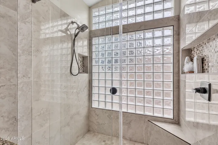 Oversized walk in shower with tile surrounds and glass door enclosure...