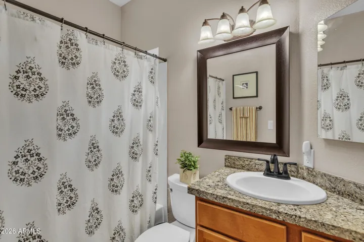 ...with granite vanity top and upgraded lights, faucet and fixtures