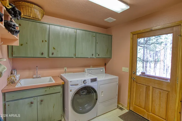 Laundry with door leading out to back deck