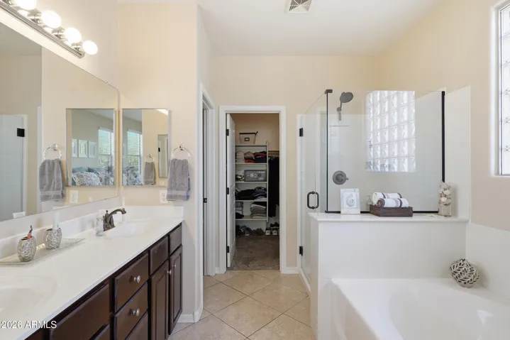 Walk in shower, two sinks, tub and walk in closet