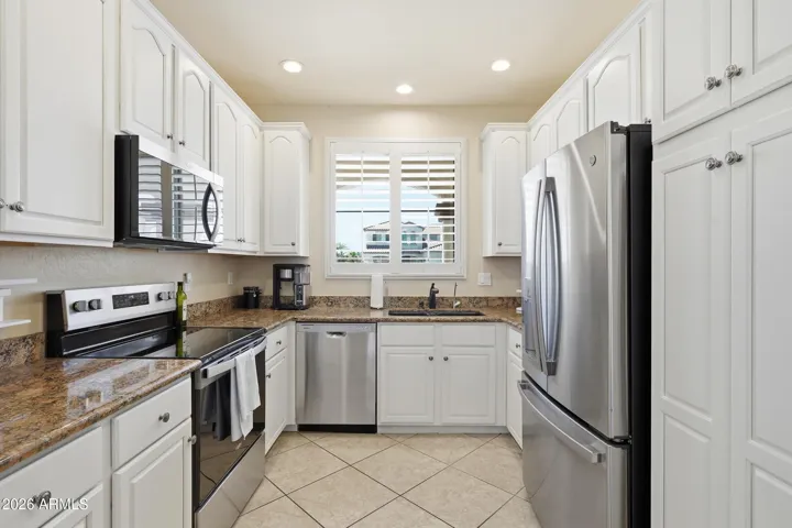 White cabinets help open up the space, granite counters, under mount sink, Stainless appliances