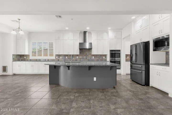 White shaker cabinets with uppers that go all the way to the ceiling