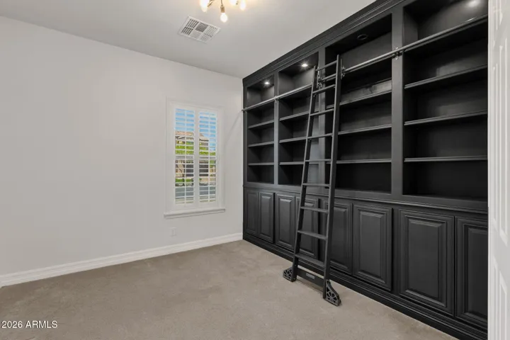 Beautifully built custom library with rolling ladder. Great room for home office, library or make it your own personal retreat.