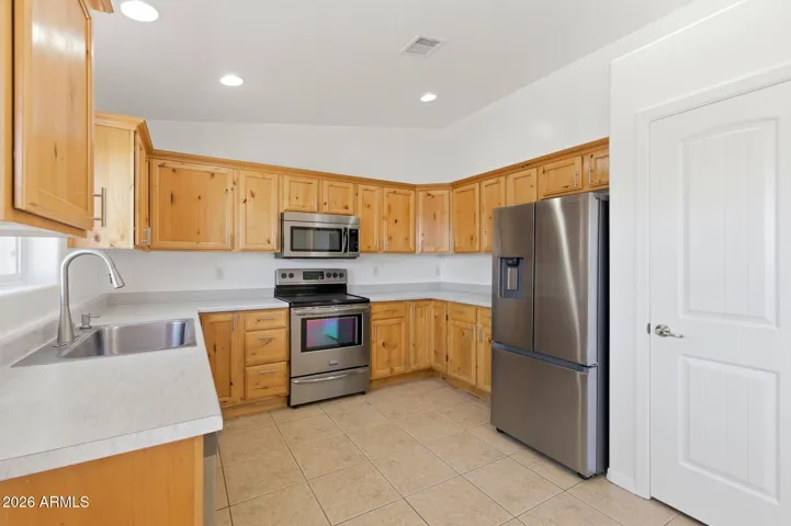 With pantry and stainless steel appliances