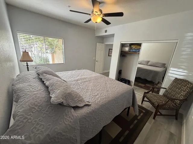 East Bedroom spacious with French Doors, ceiling fan and large window