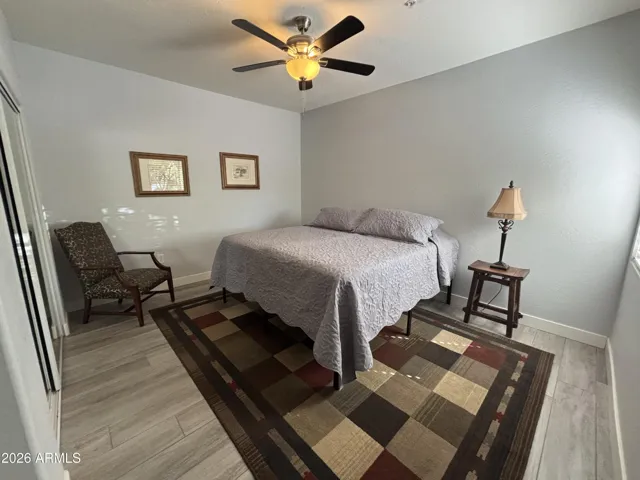 East Bedroom spacious with French Doors, ceiling fan and natural light