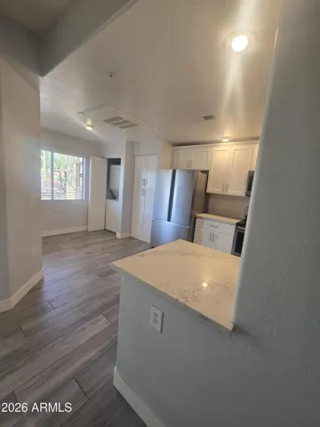 Kitchen has nook for table, Opens to Living Room and has laundry in closet