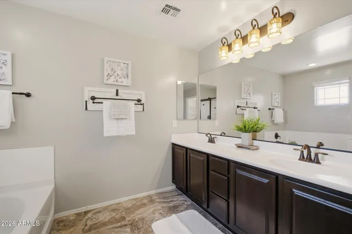 Primary bathroom has separate tub and shower, two closets and a private toilet room.