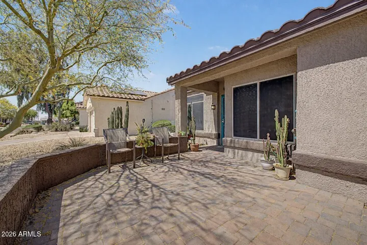 Inviting front pavered patio with charming pony wall. Perfect for enjoying Arizona mornings and evenings.