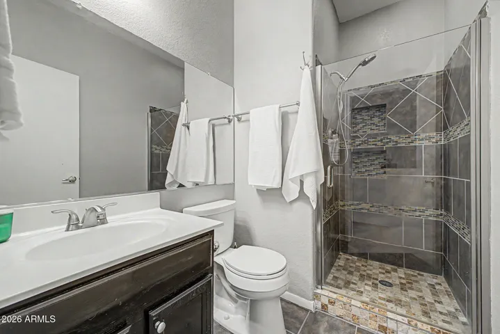 Guest bathroom features a new tile walk-in shower.