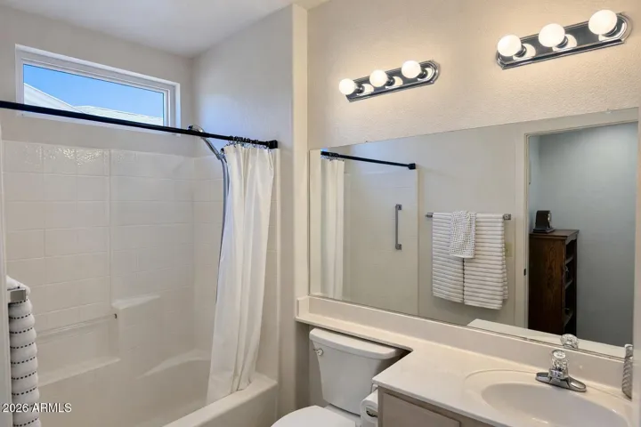 Bright full bath with tub/shower combo and natural light window