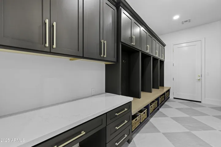 The mud room is complete with custom cabinets, outlets in each bay and plenty of storage!