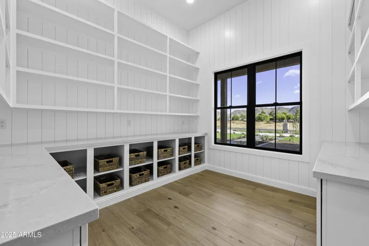 The pantry is a room of it's own! Tons of custom cabinets and shelving provide more than enough room for anything you need to put in here:)