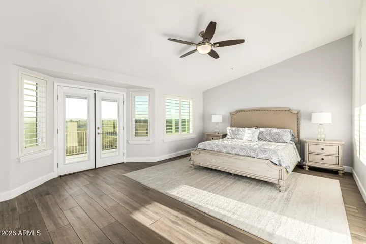 primary bedroom with french doors to large balcony