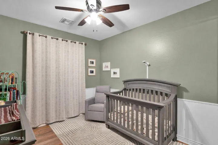 Secondary bedroom featuring custom wainscoting.