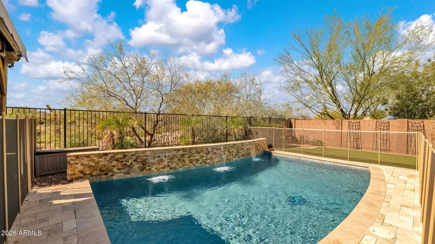 Backyard opens to the arroyo with no rear neighbors, offering a private, natural backdrop and the kind of setting where Arizona sunsets bring incredible color and beauty to the horizon.