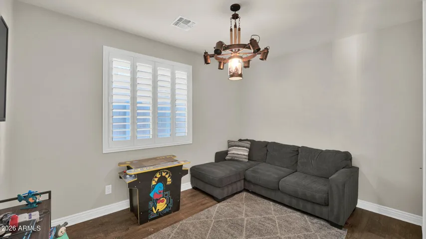 Centrally located den/office with double doors, offering flexibility for a home office, media room, or additional living space.