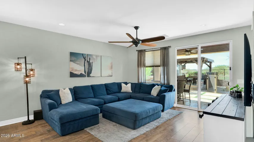 Open great room with sliding doors that extend the living space outdoors, creating a seamless connection to the backyard and maximizing natural light and views.