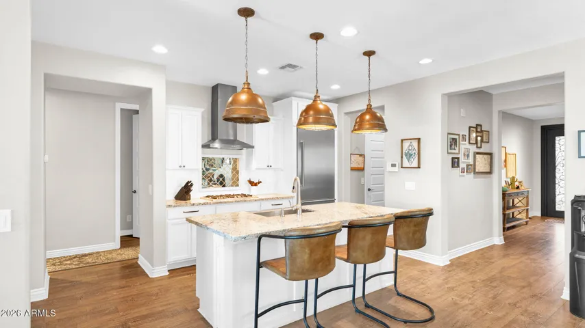 Rich, durable hard surface flooring carried throughout the home, offering a clean, cohesive look with no carpet.