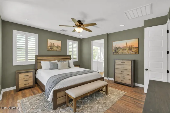 Spacious primary suite with private sliding door access to the covered patio, offering a quiet retreat with easy indoor-outdoor living.