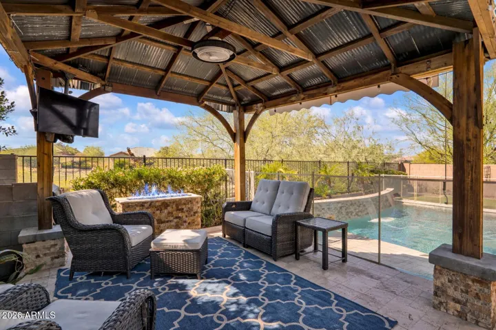 Elevated gazebo with ceiling fan, providing welcome shade from the Arizona sun and a comfortable space for relaxing evenings and year-round enjoyment.
