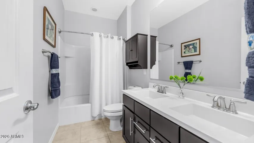 Second bathroom with double sinks and tons of under counter storage.