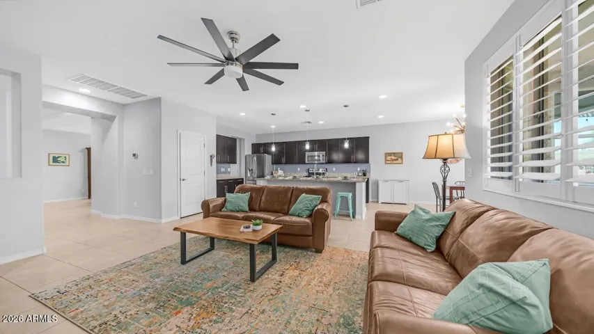 Family room with shutters and contemporary ceiling fan