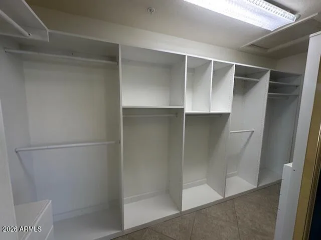 The primary closet has been upgraded with a built-in system that allows for a variety of items and lots of storage.