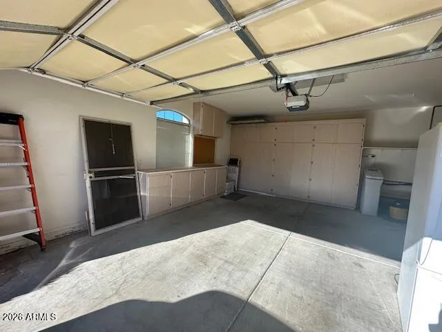 The garage is equipped with cabinets, shelves and an insulated garage door.
