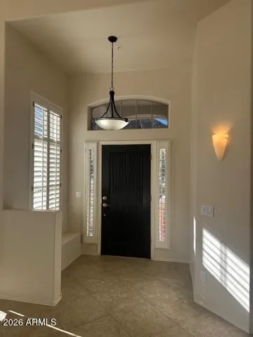 As you walk in this exquisite home you will immediately see the foyer with high ceilings, custom tile and decorative lighting.