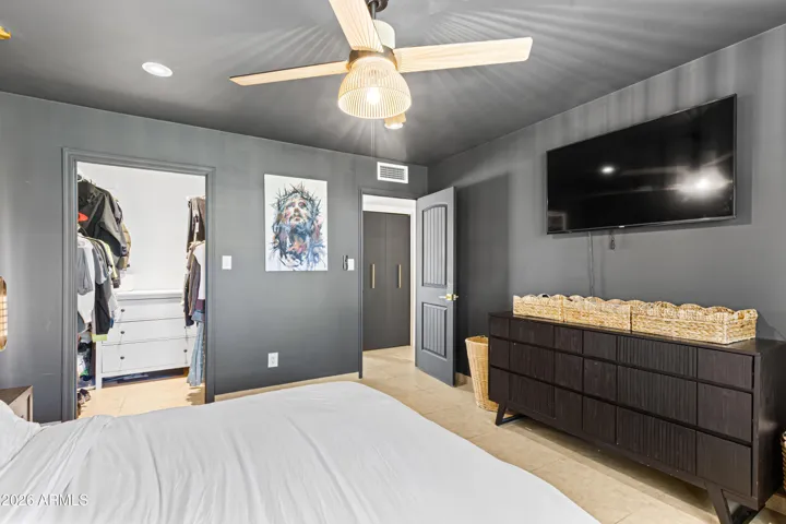 Open, warm yet stylish master bedroom.