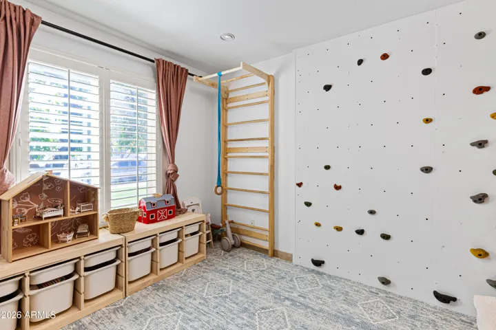 Kids room with built in rock wall.