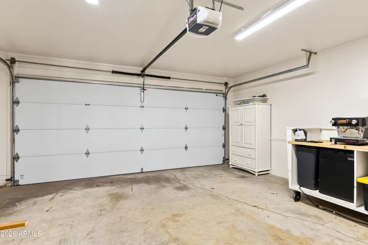 Large garage with insulated doors and opener.