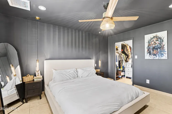 Large master suite with walk in closet, and overlooking the grassy back yard.