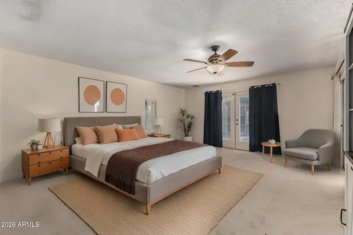 Staged master bedroom. 2 entrances into back for the patio and pool area.