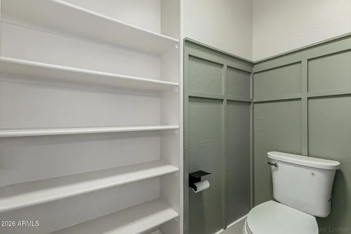 Primary bathroom w/ storage shelves & custom wood work