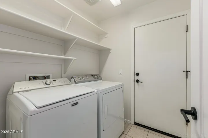 Inside laundry room w/ shelves
