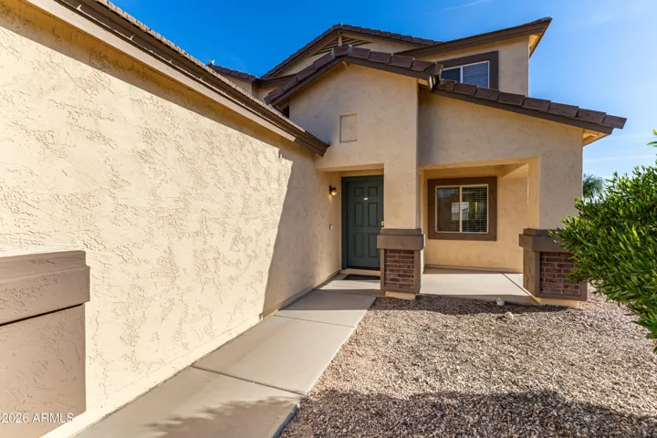 Welcoming teal front door and patio.