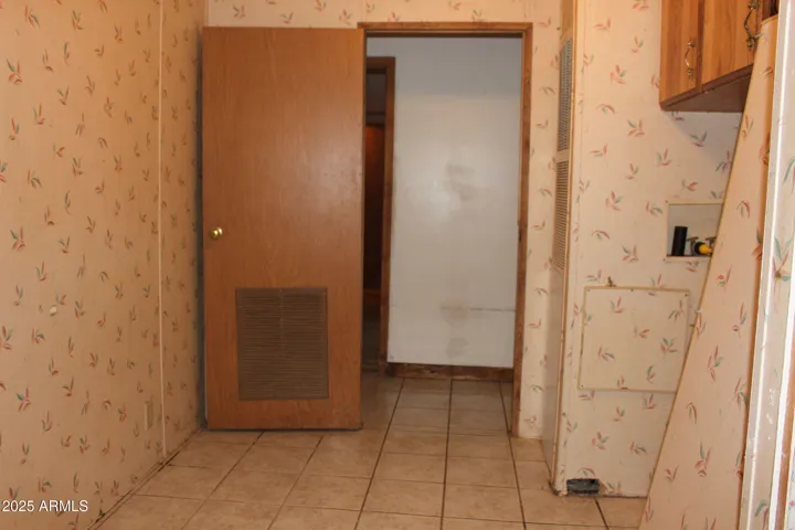 Utility room has space for w/d and lots of area for freezers, wine refrigerator