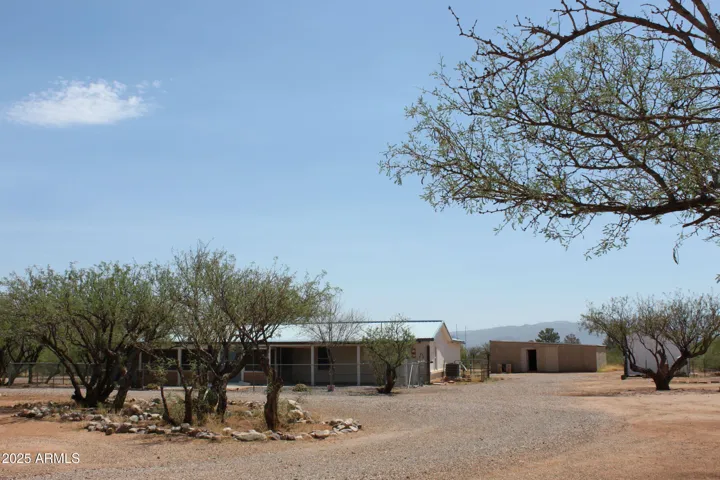 Circle drive leads to house, backyard to the garage