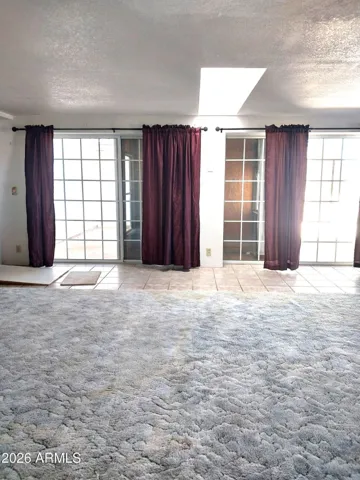 Dual slider doors lead to courtyard..cat shelter is visible in right hand door