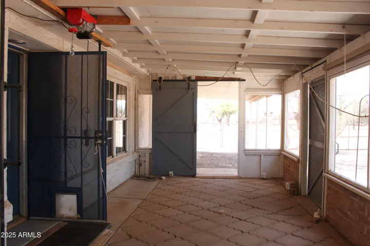 Barn doors accent covered front patio and plant station