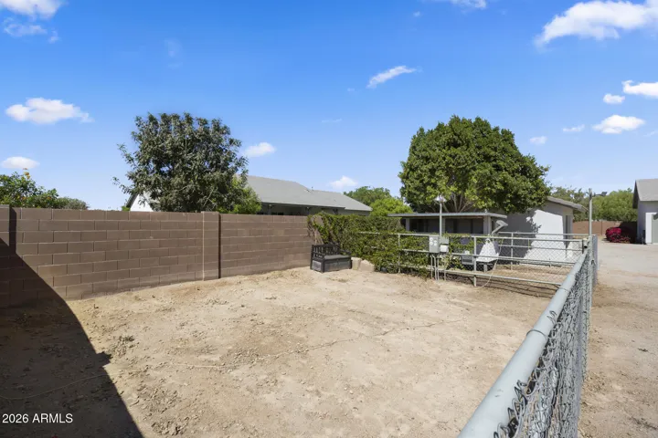 fenced garden space with watering system