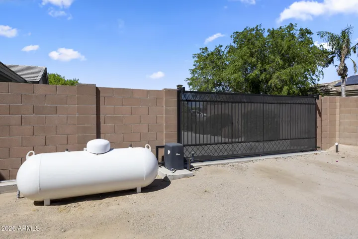 owned 250 gallon propane tank inside the fence near the electric gate