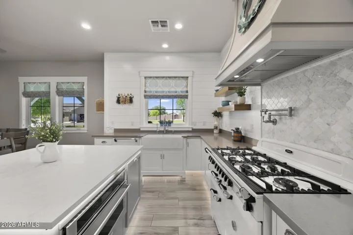 kitchen with view of built in microwave and upgraded appliances