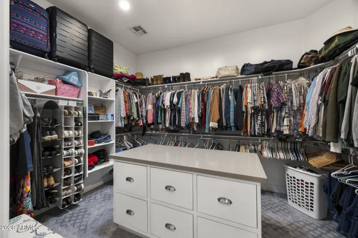 primary suite walk in closet with island