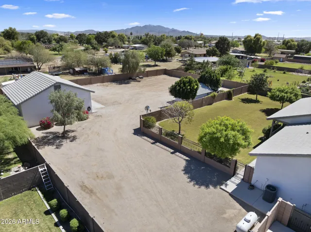past the electronic gate to the detached garage and more